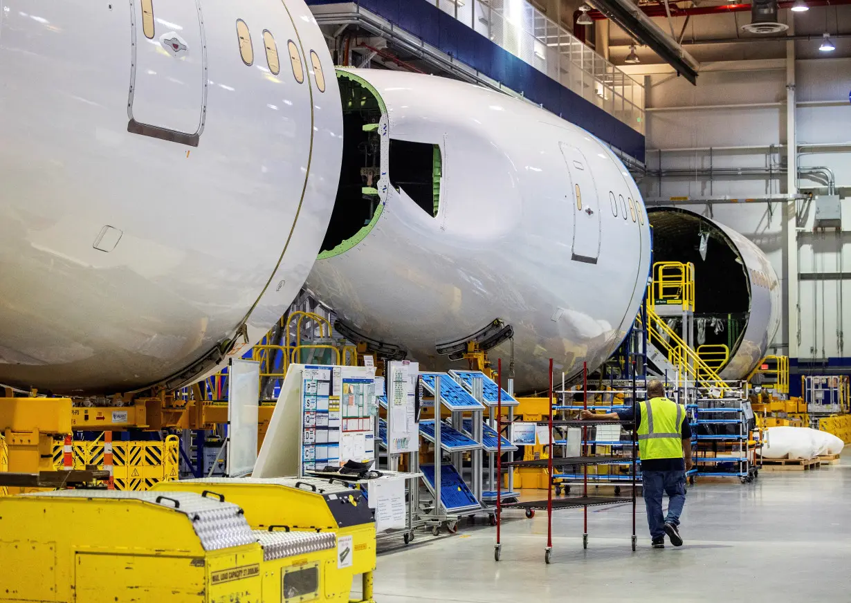 FILE PHOTO: An employee walks past a fuselage section under construction at Boeing Co.'s 787 Dreamliner campus in North Charleston, South Carolina