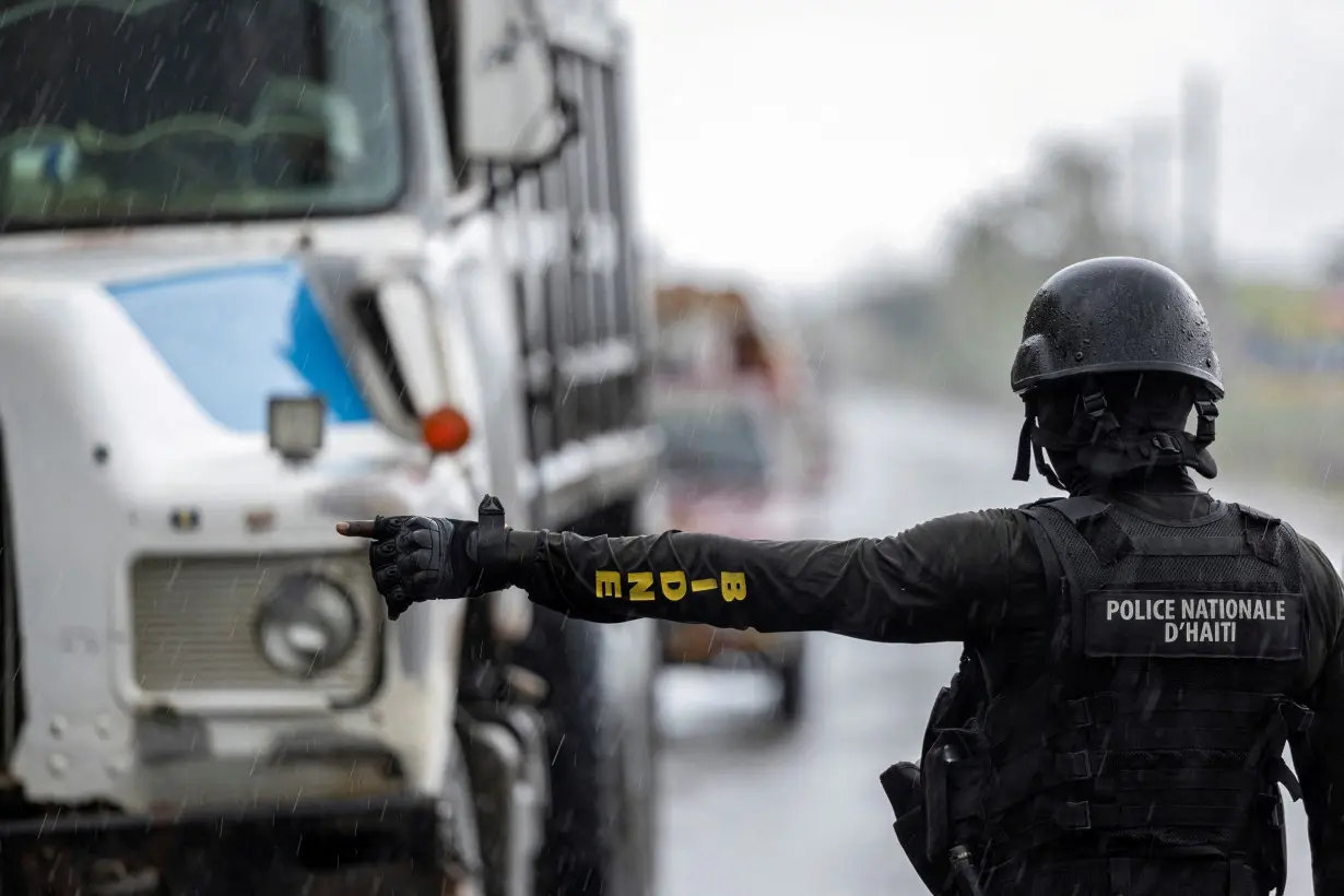 FILE PHOTO: A Haitian National Police officer stops a truck at a security checkpoint in Limonade