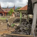 Indonesian rescuers search through rivers and rubble after flash floods that killed at least 50