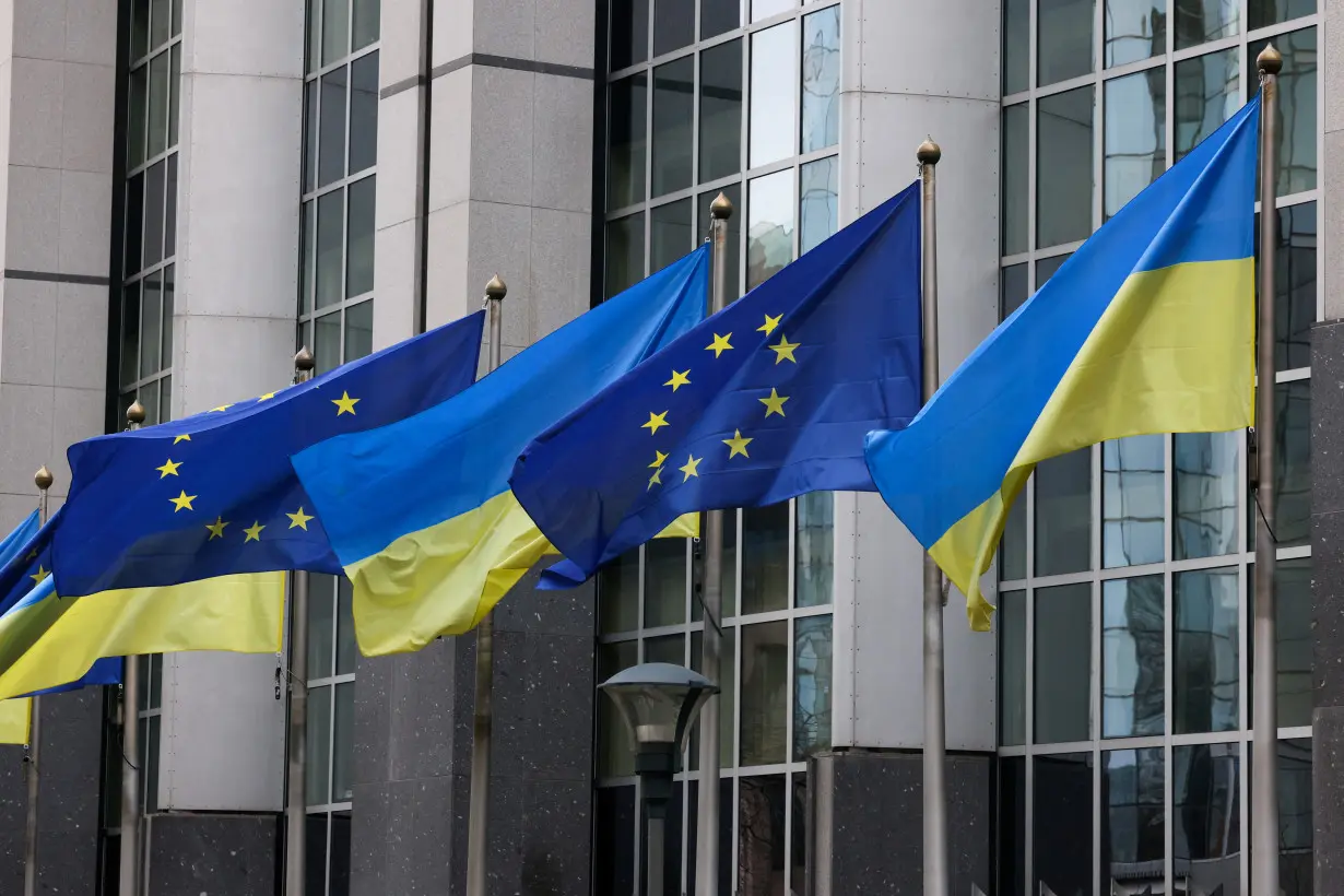 FILE PHOTO: Flags of Ukraine fly in front of the EU Parliament building on the first anniversary of the Russian invasion