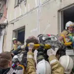 Apartment building partially collapses in a Russian border city after shelling. At least 13 killed