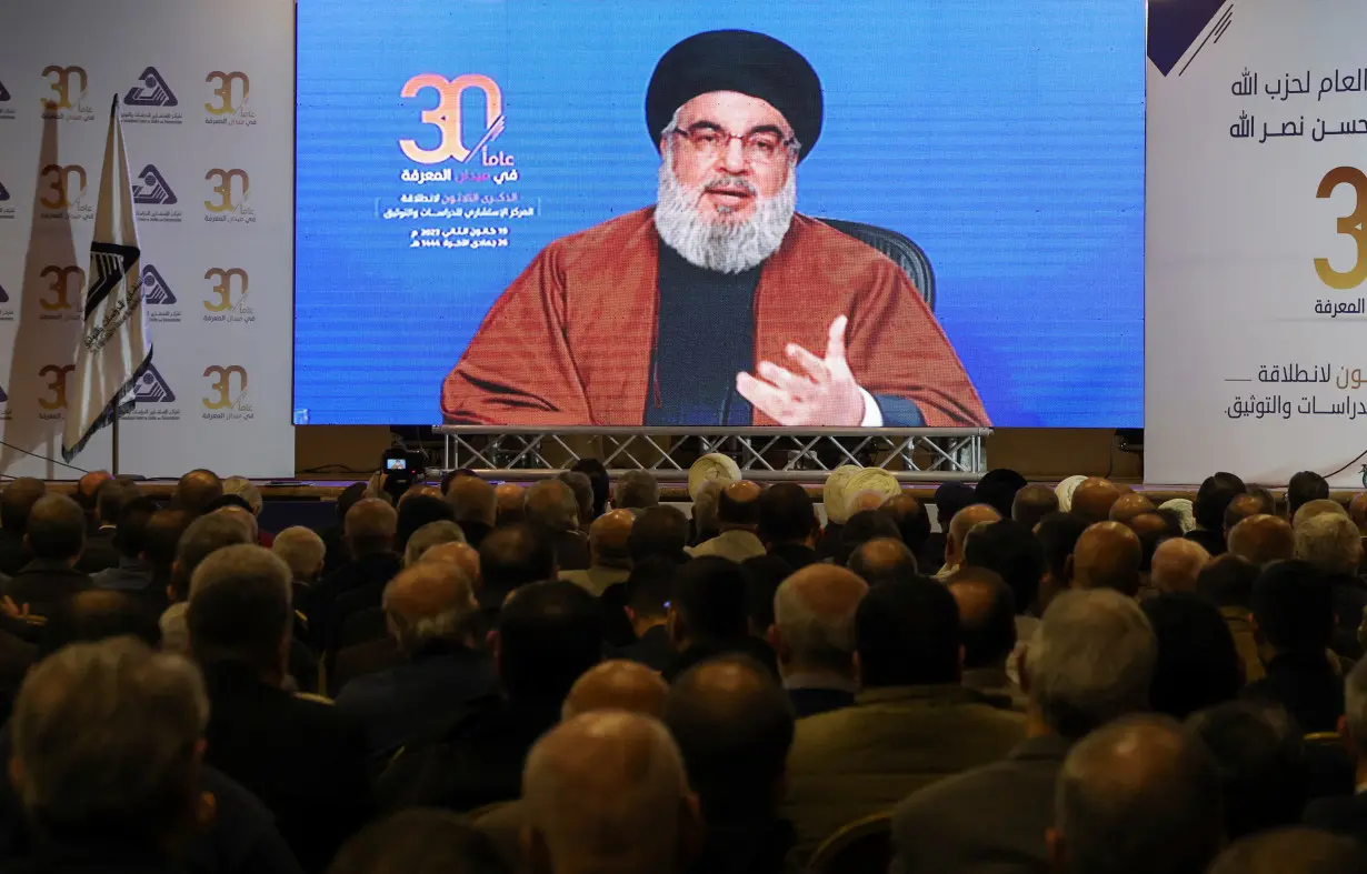 Lebanon's Hezbollah leader Sayyed Hassan Nasrallah gestures as he addresses his supporters through a screen in Beirut's southern suburbs, in Beirut