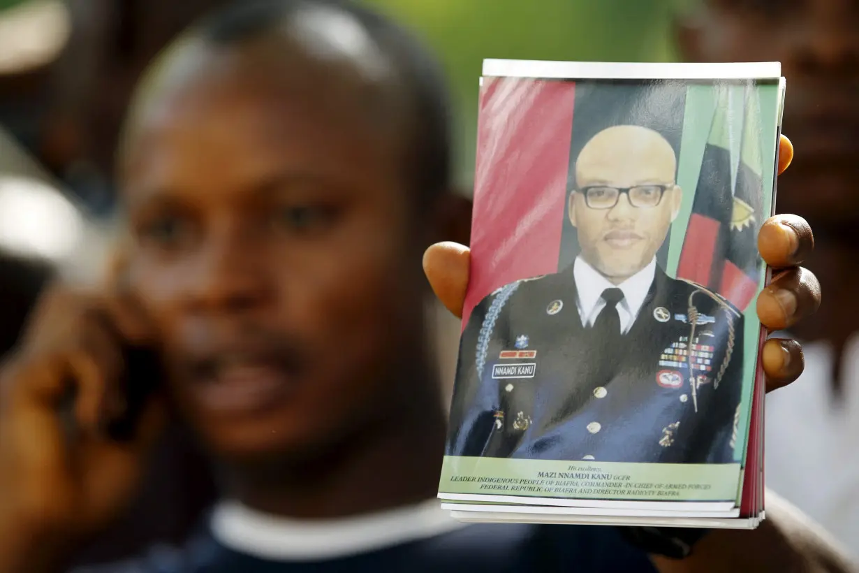 FILE PHOTO: A supporter of Indigenous People of Biafra (IPOB) leader Nnamdi Kanu holds a photograph of Kanu, who is expected to appear at a magistrate court, during a rally in Abuja