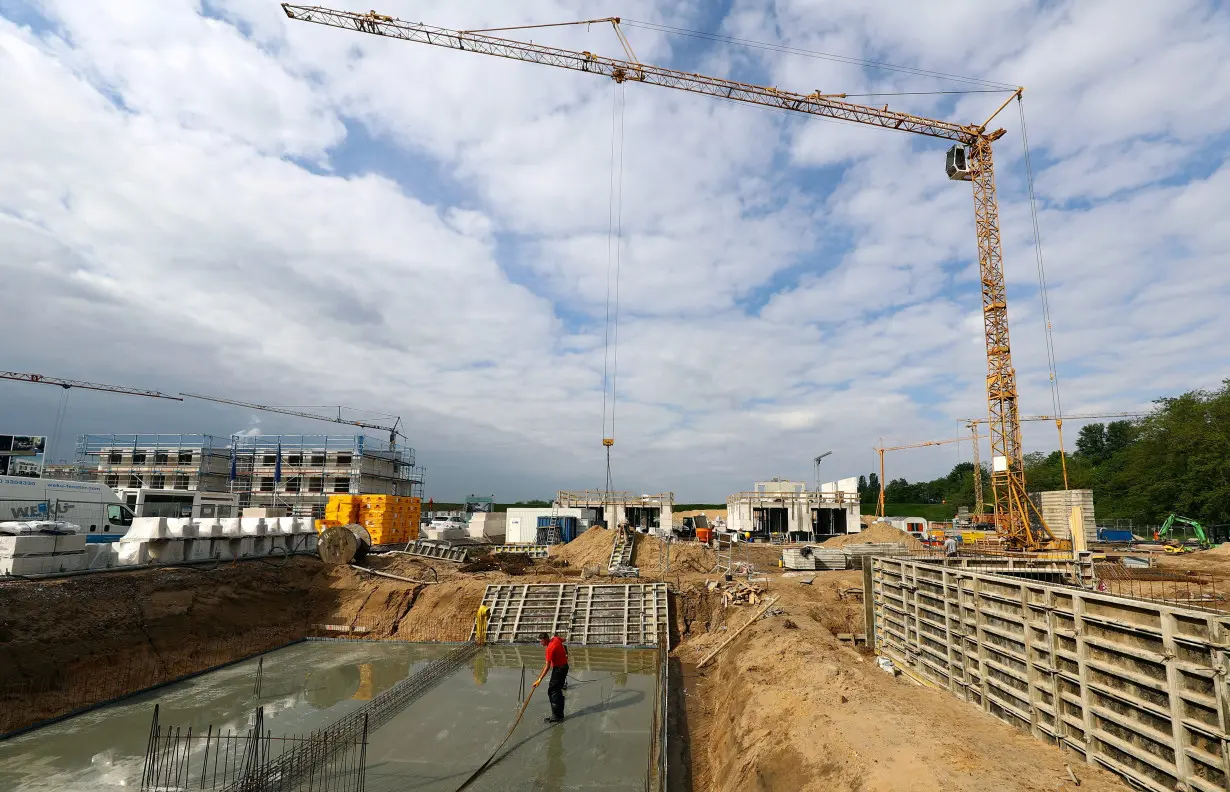 FILE PHOTO: Workers are seen on a construction site for family homes in Hanau near Frankfurt