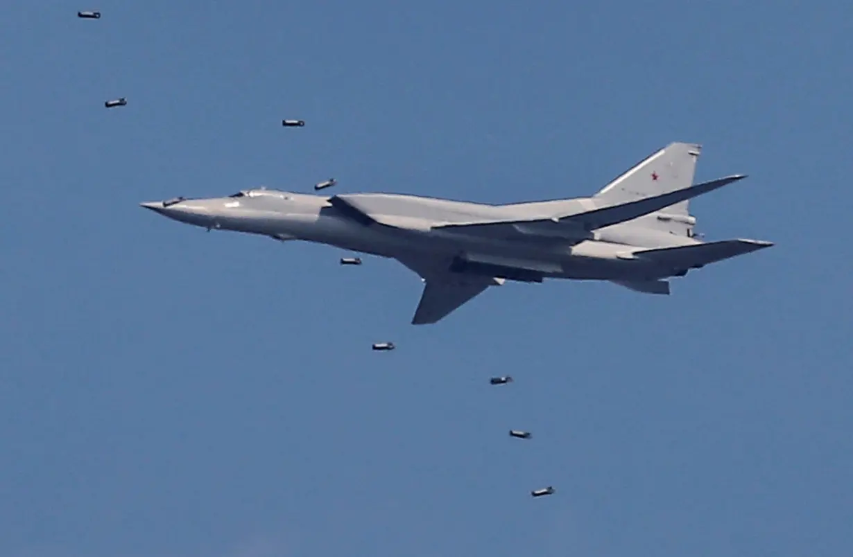 FILE PHOTO: A Tupolev Tu-22M3 strategic bomber drops bombs during the Aviadarts competition at the Dubrovichi range outside Ryazan