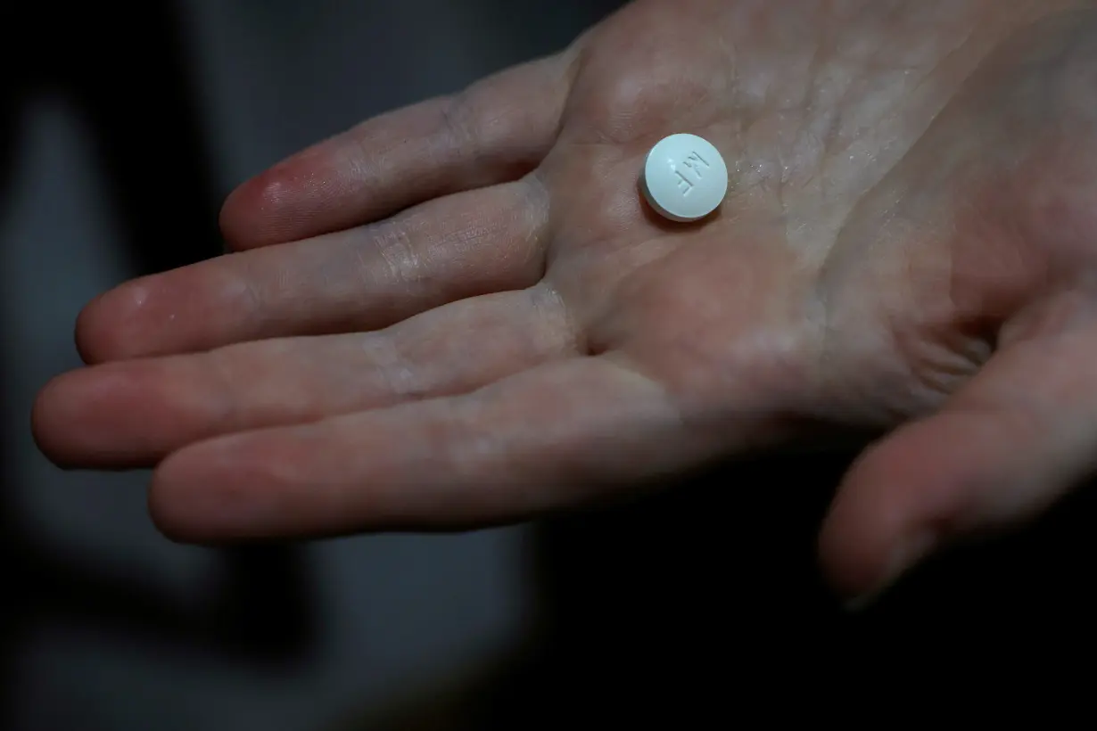 FILE PHOTO: A patient prepares to take Mifepristone, the first pill in a medical abortion, at Alamo Women's Clinic in Carbondale, Illinois