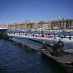 The Olympic torch is being welcomed in French port city of Marseille with fanfare and high security