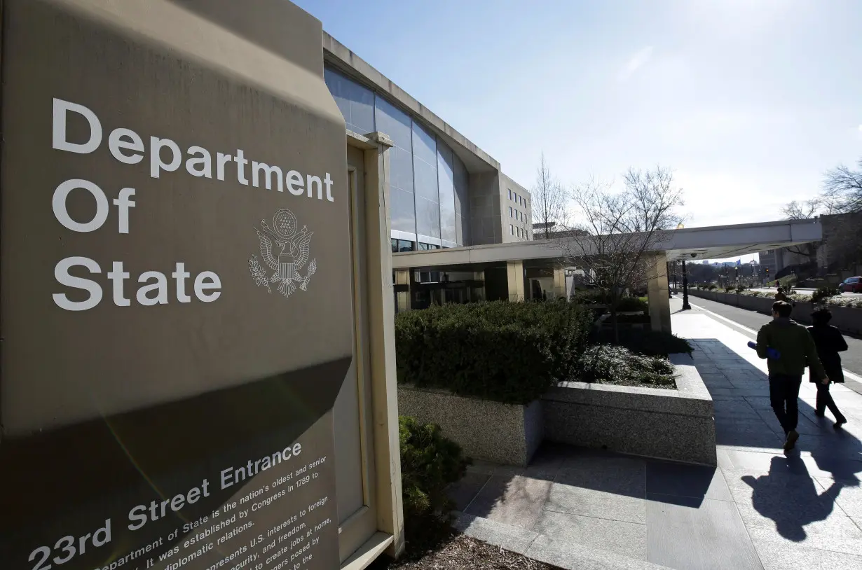 FILE PHOTO: People enter the State Department Building in Washington