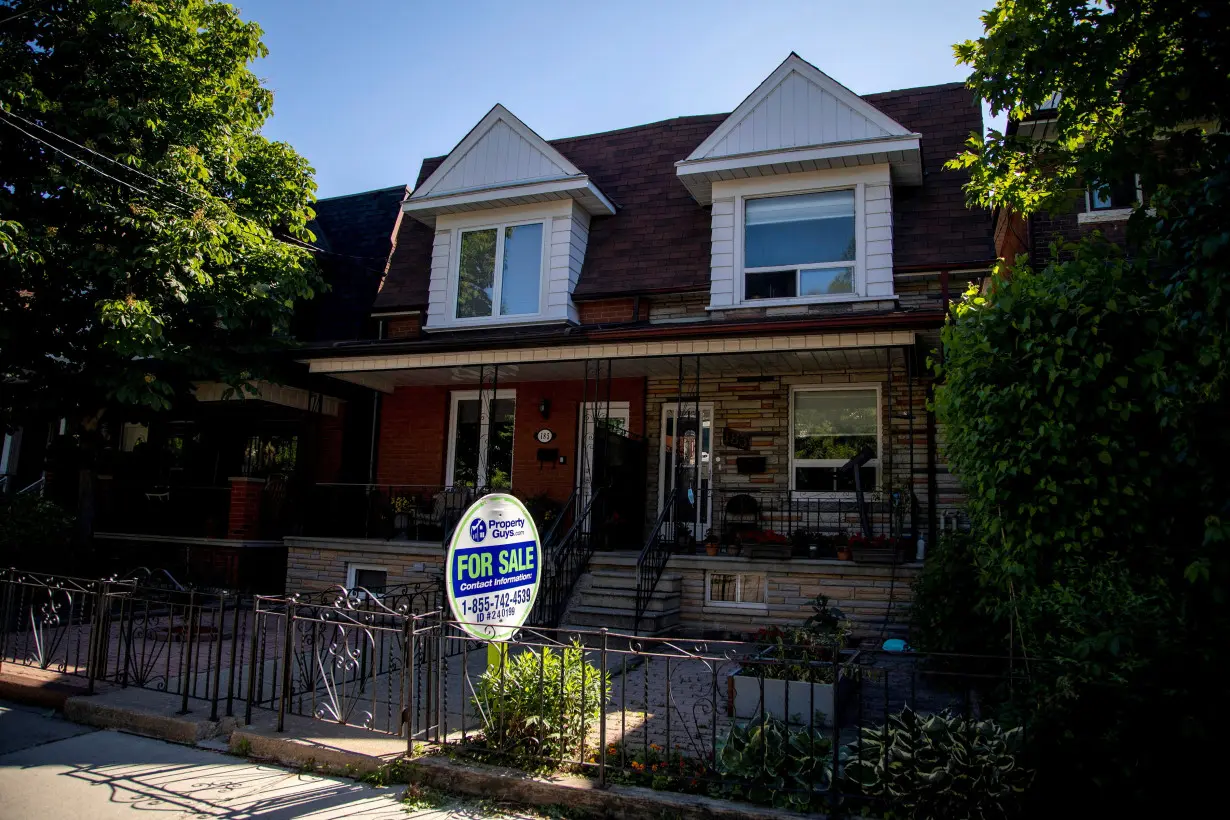 FILE PHOTO: For sale signs on homes in Toronto