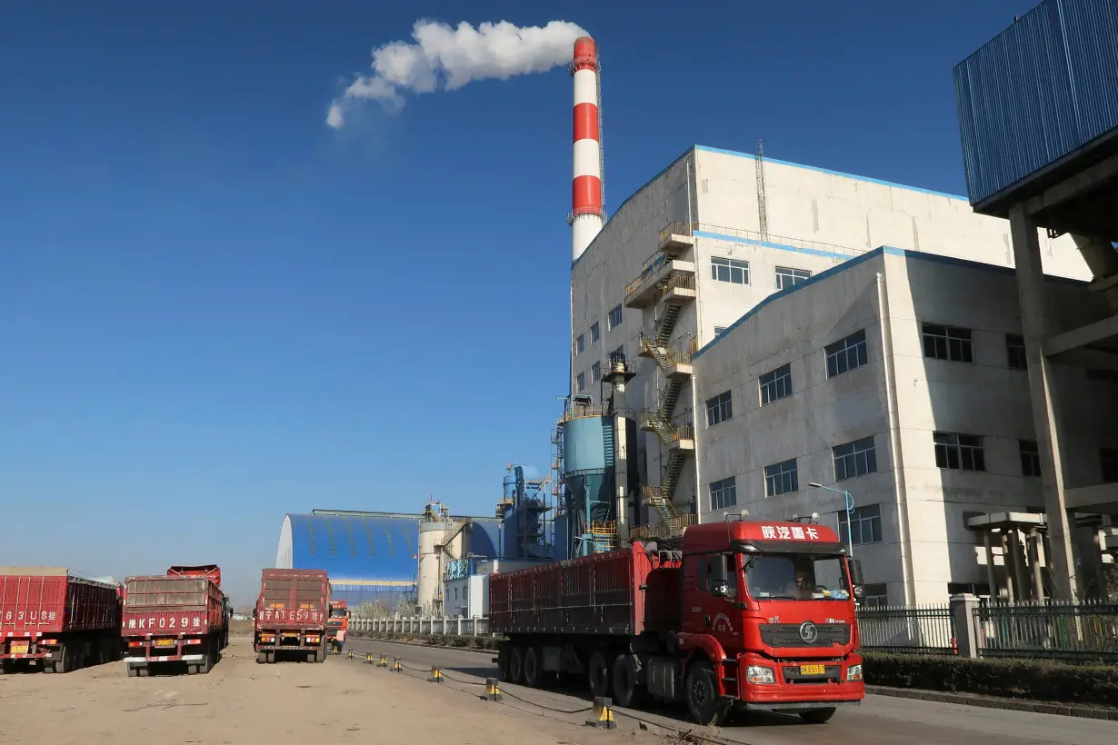 Truck passes by a chemical factory near the Jinjie Industrial Park in Shenmu