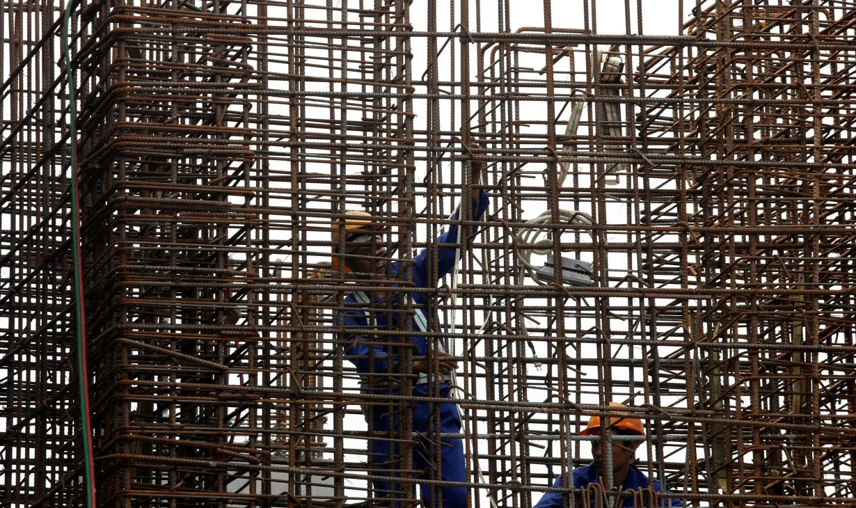 Labourers work at the construction site of a sky train station in Hanoi, Vietnam