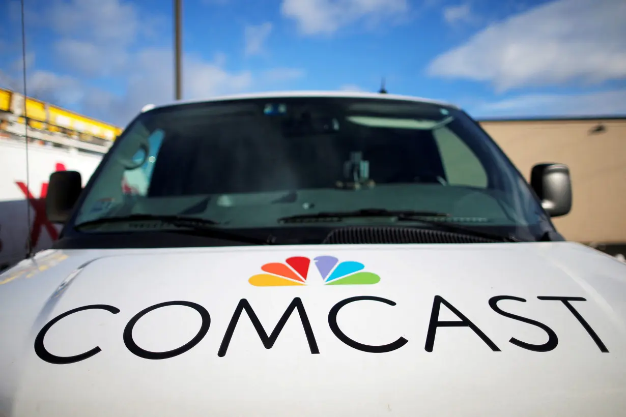 FILE PHOTO: A technician's vehicle sits in the parking lot at a Comcast facility in Lawrence