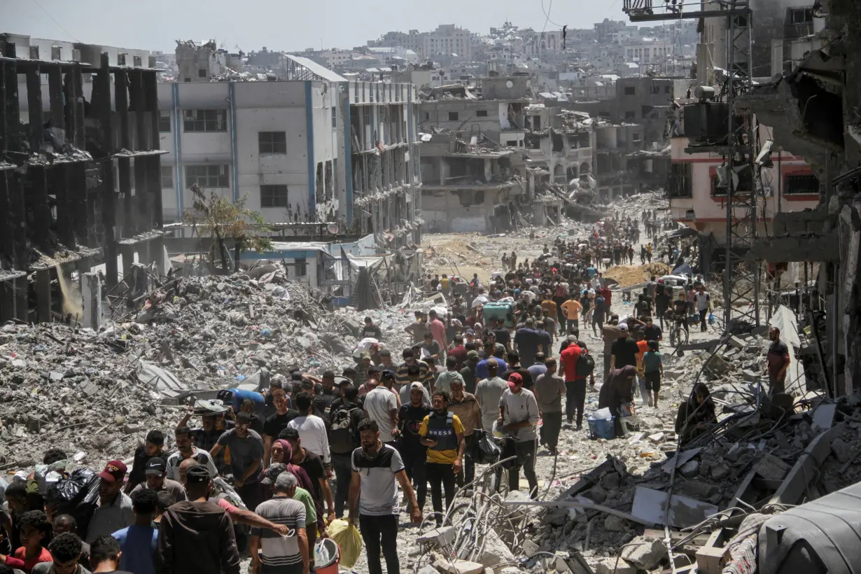 Palestinians inspect the damages after Israeli forces withdrew from a part of Jabalia refugee camp, in the northern Gaza Strip