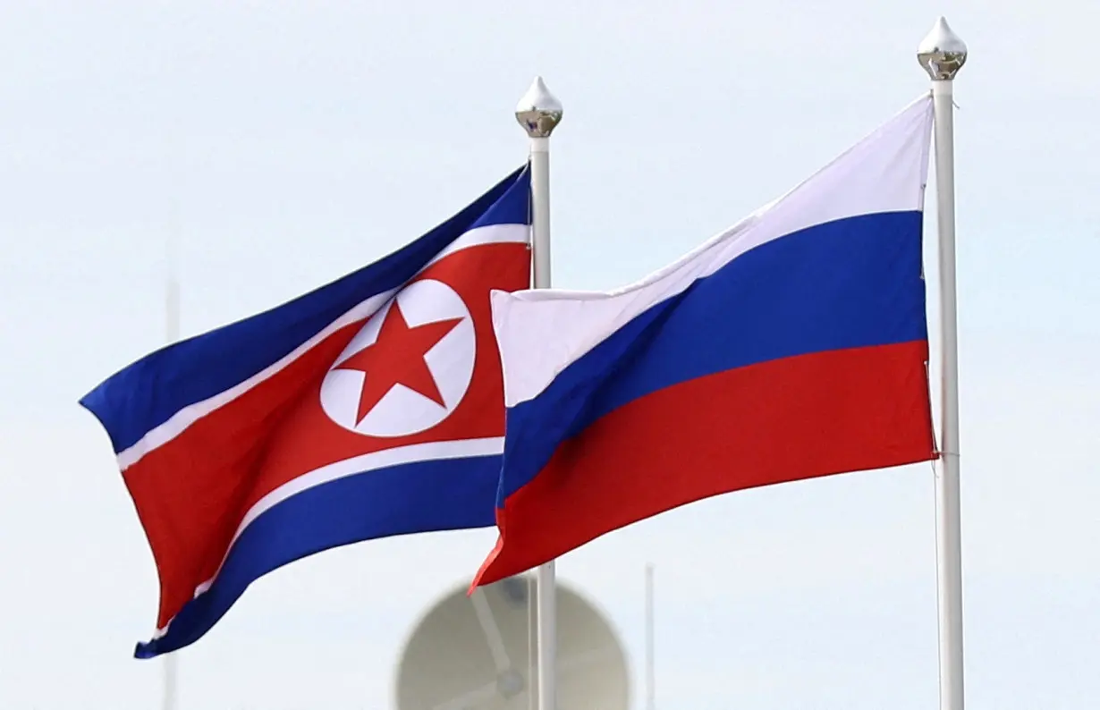 FILE PHOTO: Russian and North Korean flags fly at the Vostochny Сosmodrome in Russia.