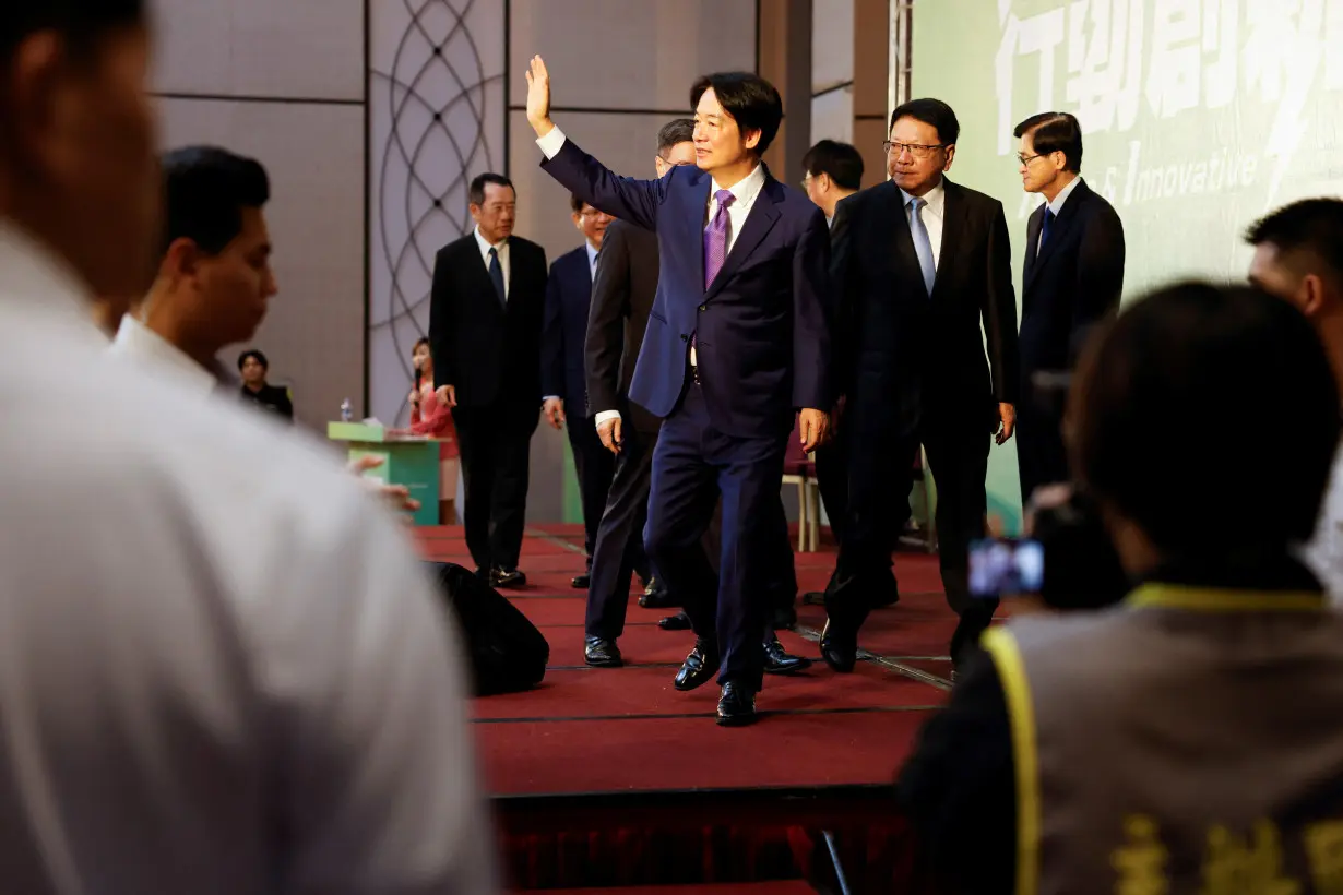 Taiwan President-elect Lai Ching-te speaks waves during a press conference in Taipei