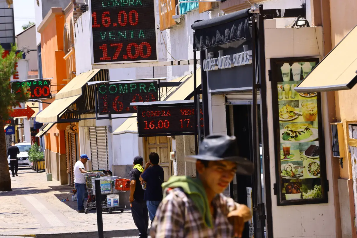 FILE PHOTO: Boards displaying the exchange rate of the Mexican peso against the U.S. dollar are pictured outside exchange houses in Ciudad Juarez