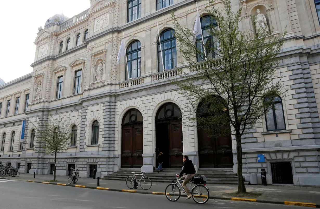 FILE PHOTO: A cyclist rides past a building of Ghent University