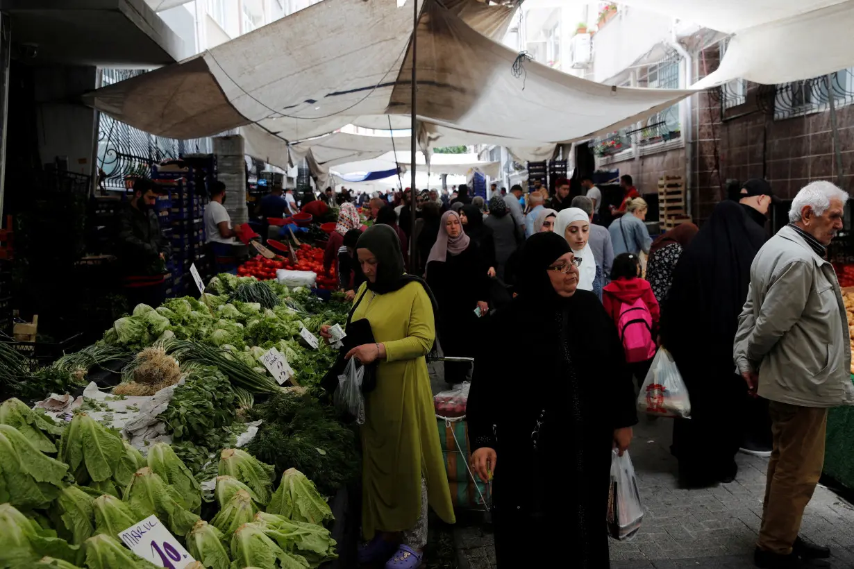 FILE PHOTO: People shop at a market in Istanbul