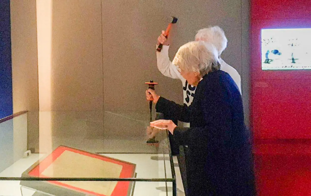 Elderly climate activists damage Magna Carta case at British Library, in London