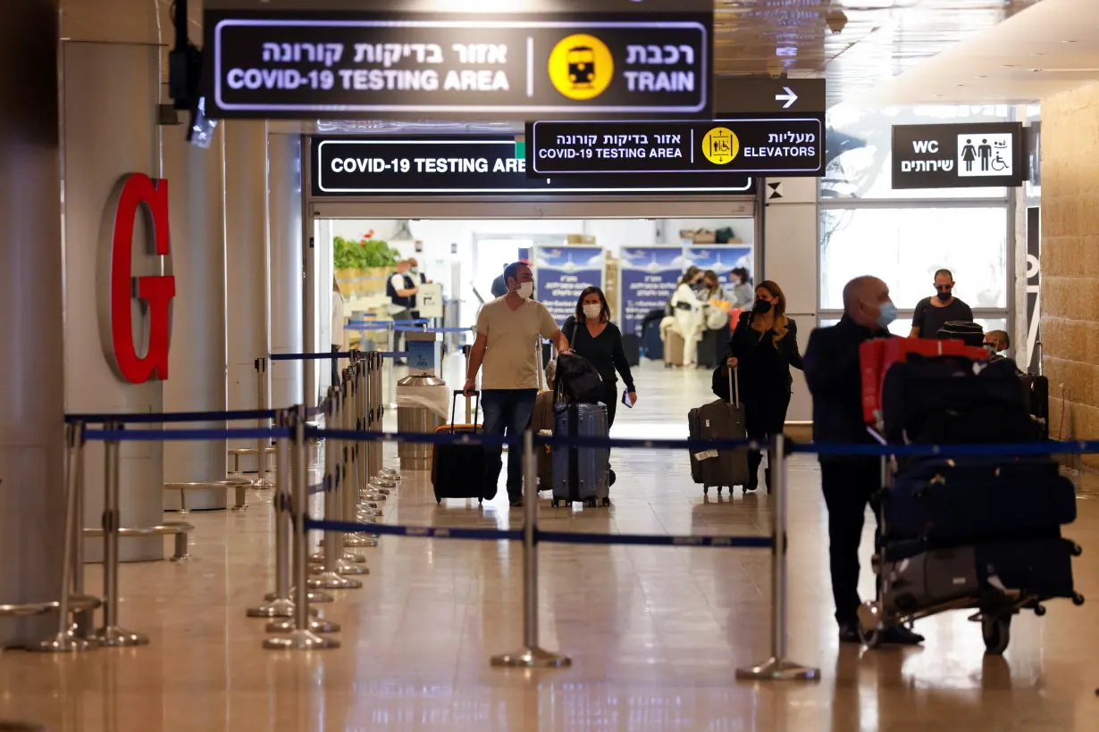 Travellers exit the coronavirus disease (COVID-19) pandemic testing area at Ben Gurion International Airport as Israel imposes new restrictions