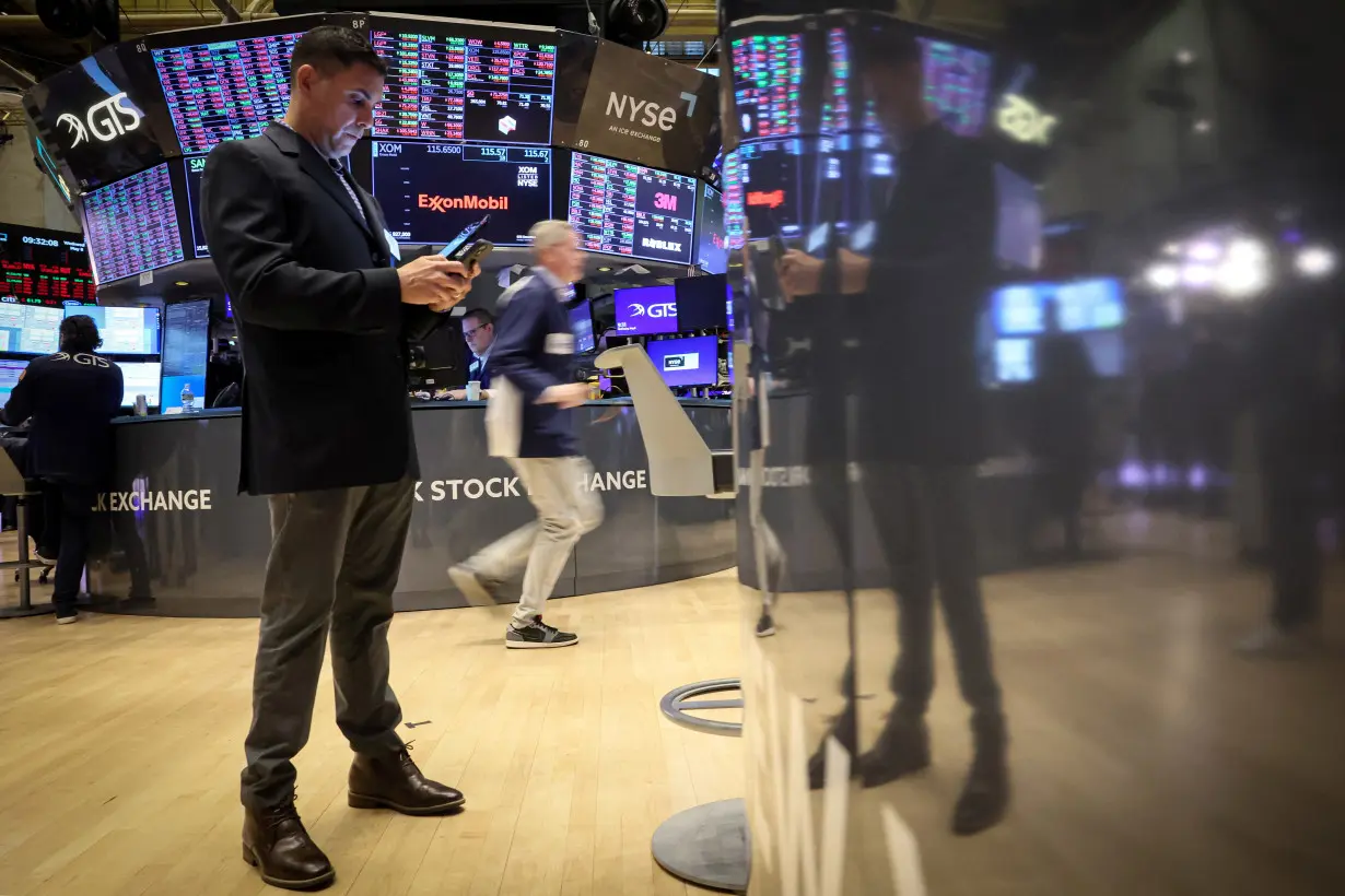 Traders work on the floor of the NYSE in New York