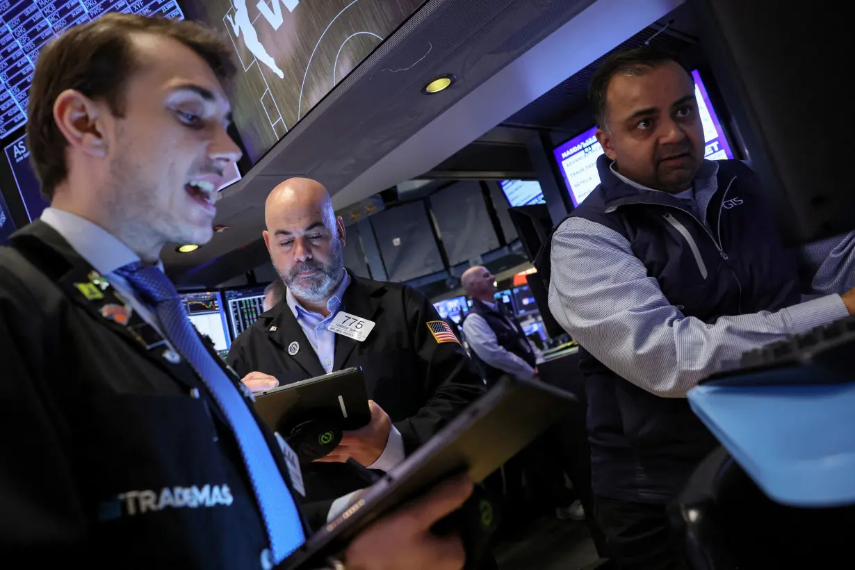 Traders work on the floor of the NYSE in New York