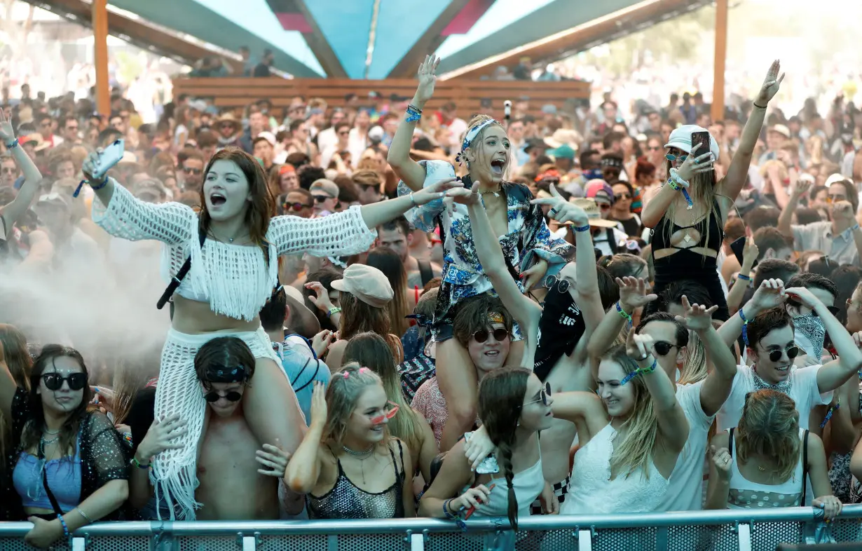 FILE PHOTO: Concertgoers dance at the Do LaB stage at the Coachella Valley Music and Arts Festival in Indio