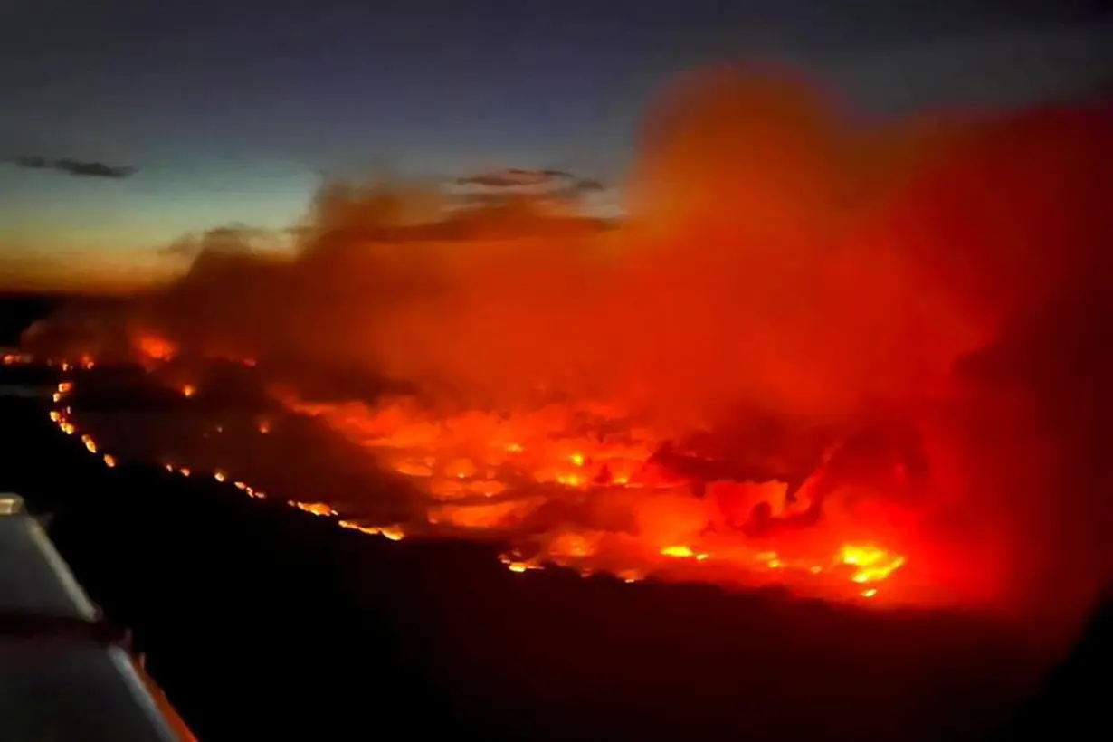 The Parker Lake wildfire glows in an aerial photograph taken by a B.C. Emergency Health Services crew member