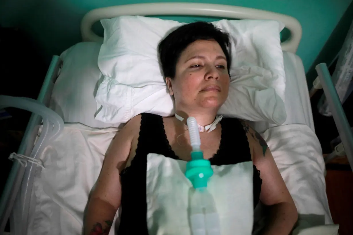 FILE PHOTO: Ana Estrada, a euthanasia advocate who suffers from an incurable condition, lies in bed at her home in Lima