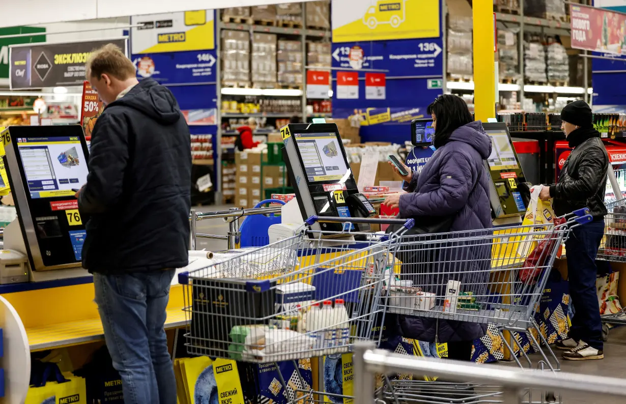 FILE PHOTO: People shop at a Metro Cash and Carry hypermarket in Moscow