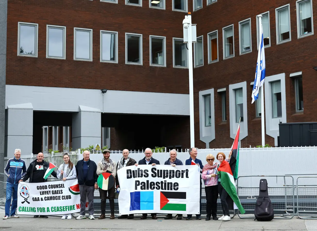 Demonstrators in support of Palestinians stand outside the Israeli embassy, in Dublin