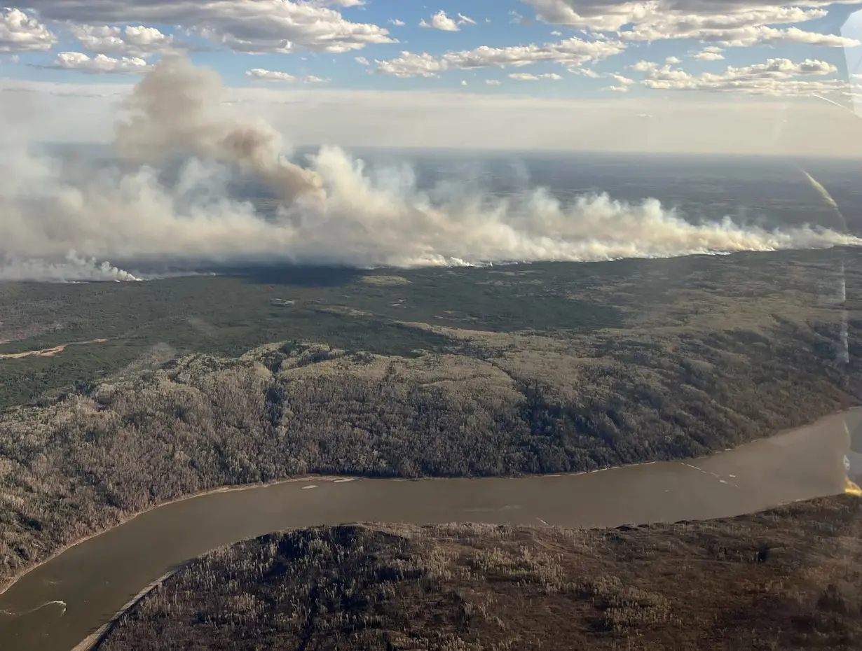 Smoke rises from wildfire MWF017 on the south side of the Athabasca River valley near Fort McMurray