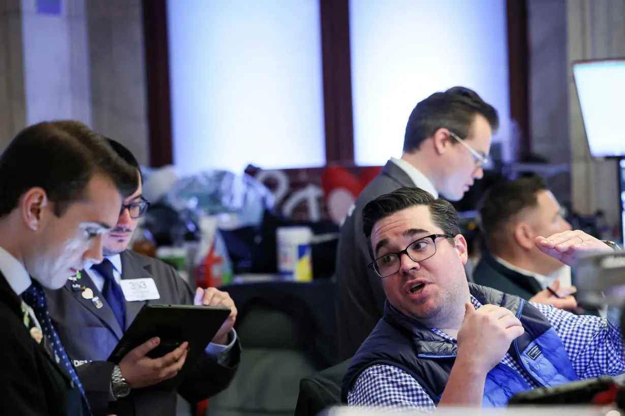 Traders work on the floor of the NYSE in New York