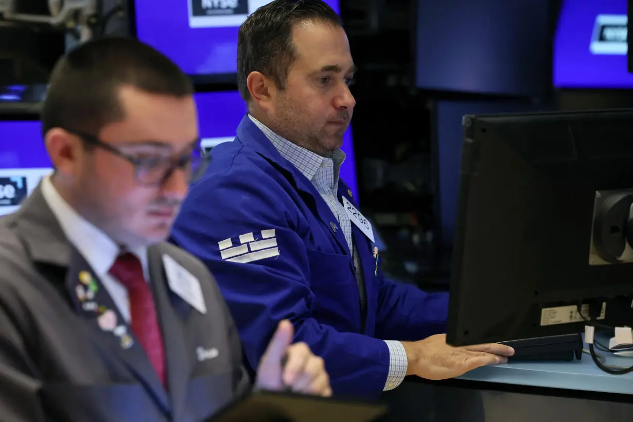 Traders work on the floor of the NYSE in New York