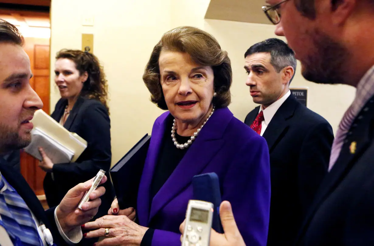 FILE PHOTO: U.S. Senator Feinstein talks to reporters as she walks to the Senate floor on Capitol Hill, in Washington