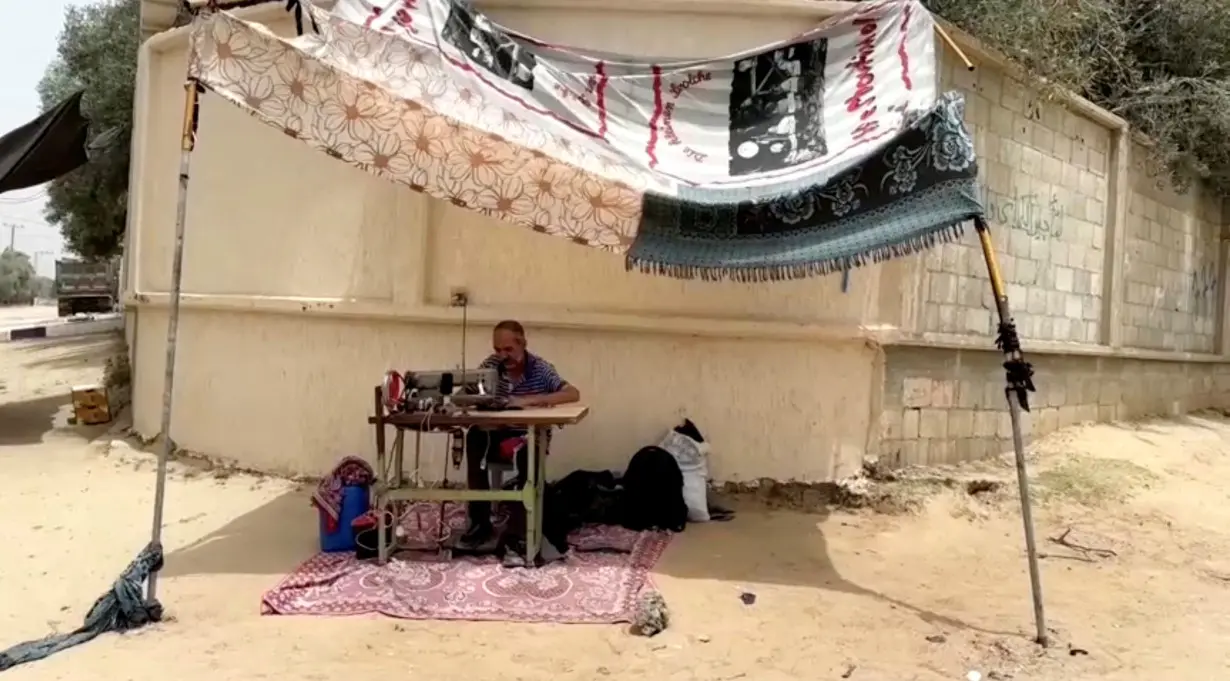 Palestinian tailor Anwar Abu Keresh alters clothes due to food scarcity, in Deir Al-Balah