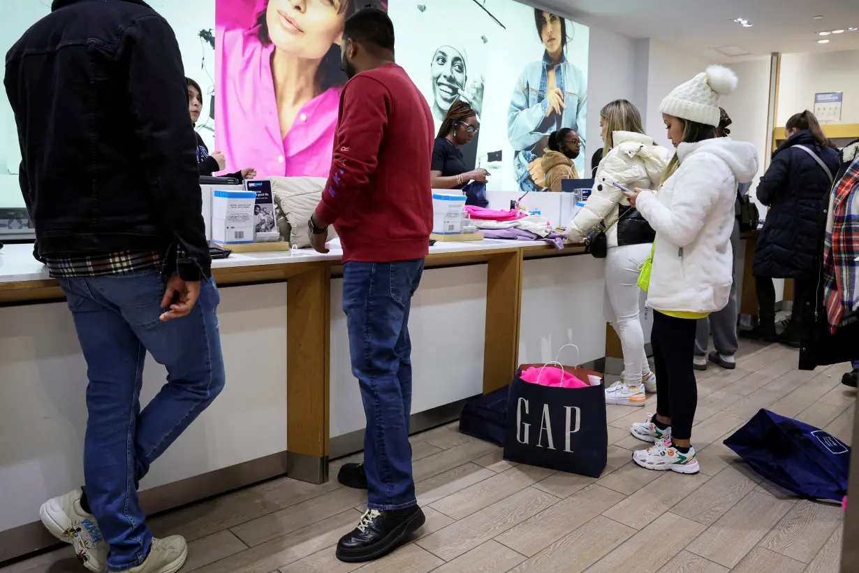 FILE PHOTO: Shoppers look for early Black Friday sales at a Gap Store in Times Square on the Thanksgiving holiday in New York