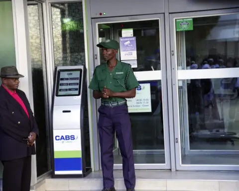 Zimbabwe authorities mix charm with force in an attempt to shore up the world’s newest currency