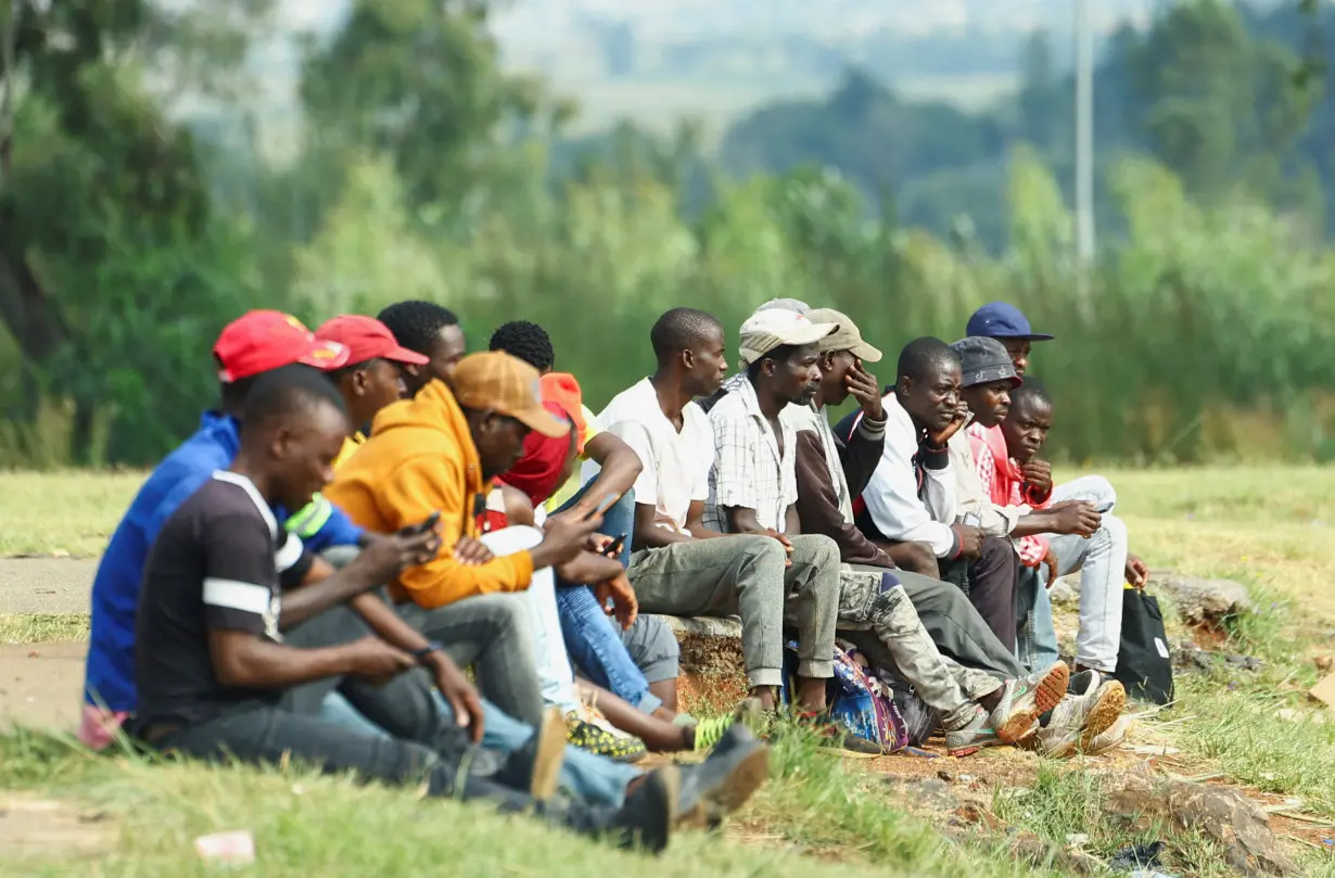 FILE PHOTO: Job seekers wait beside a road for casual work offered by passing motorists, in Eikenhof