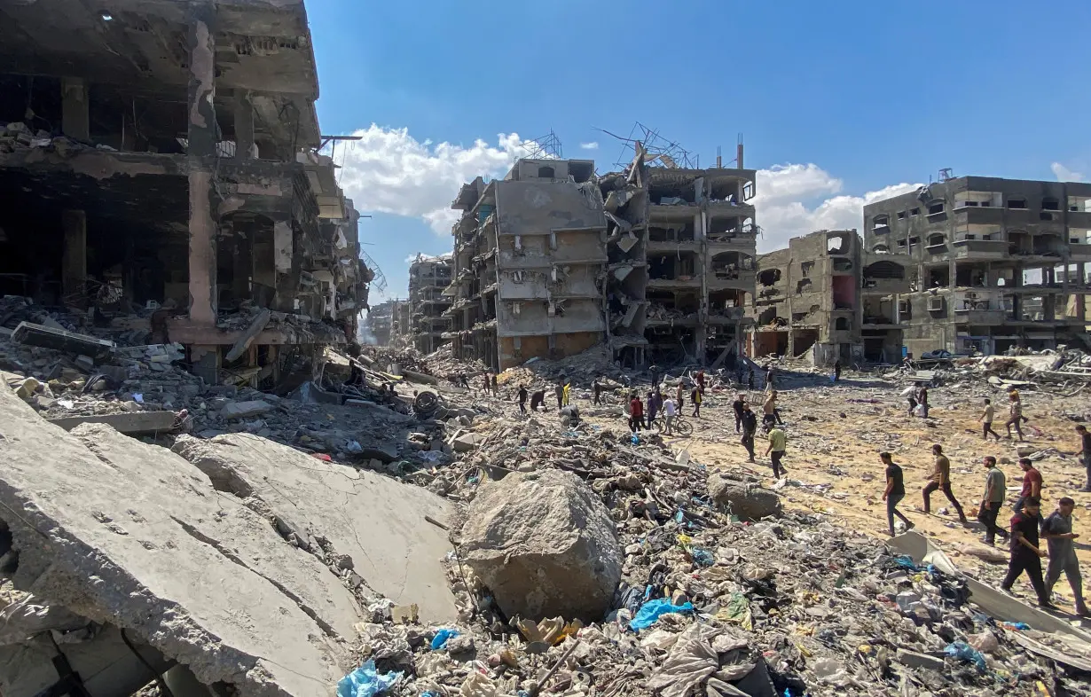 Palestinians inspect the damages after Israeli forces withdrew from a part of Jabalia refugee camp, in the northern Gaza Strip