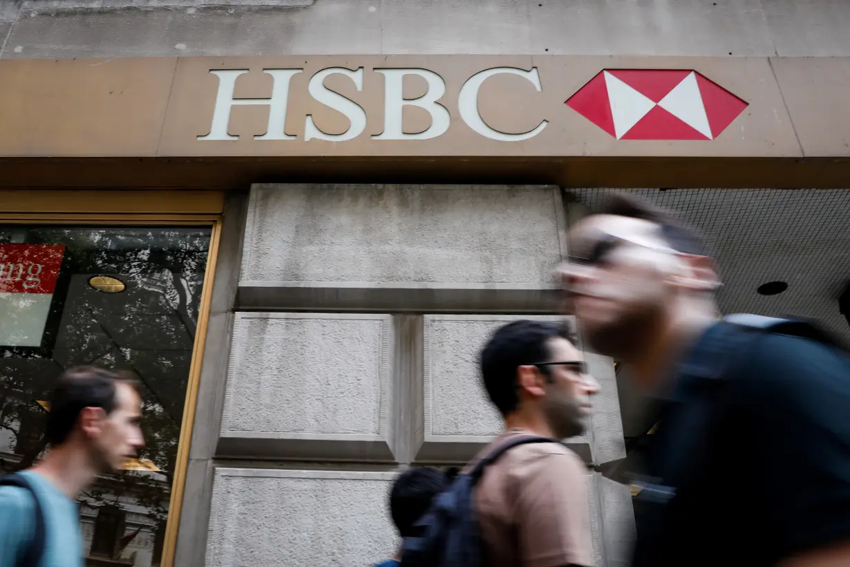 FILE PHOTO: People pass by an HSBC branch bank in the financial district in New York