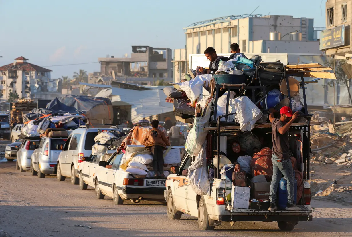 Displaced Palestinians who fled Rafah, ahead of a threatened Israeli assault, travel in Khan Younis