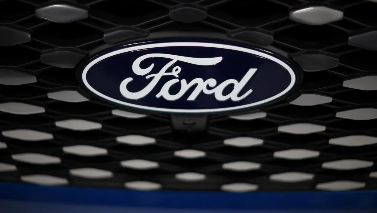 A logo is seen on the grill of an E-transit concept vehicle during a press event at the Ford Halewood transmissions plant in Liverpool