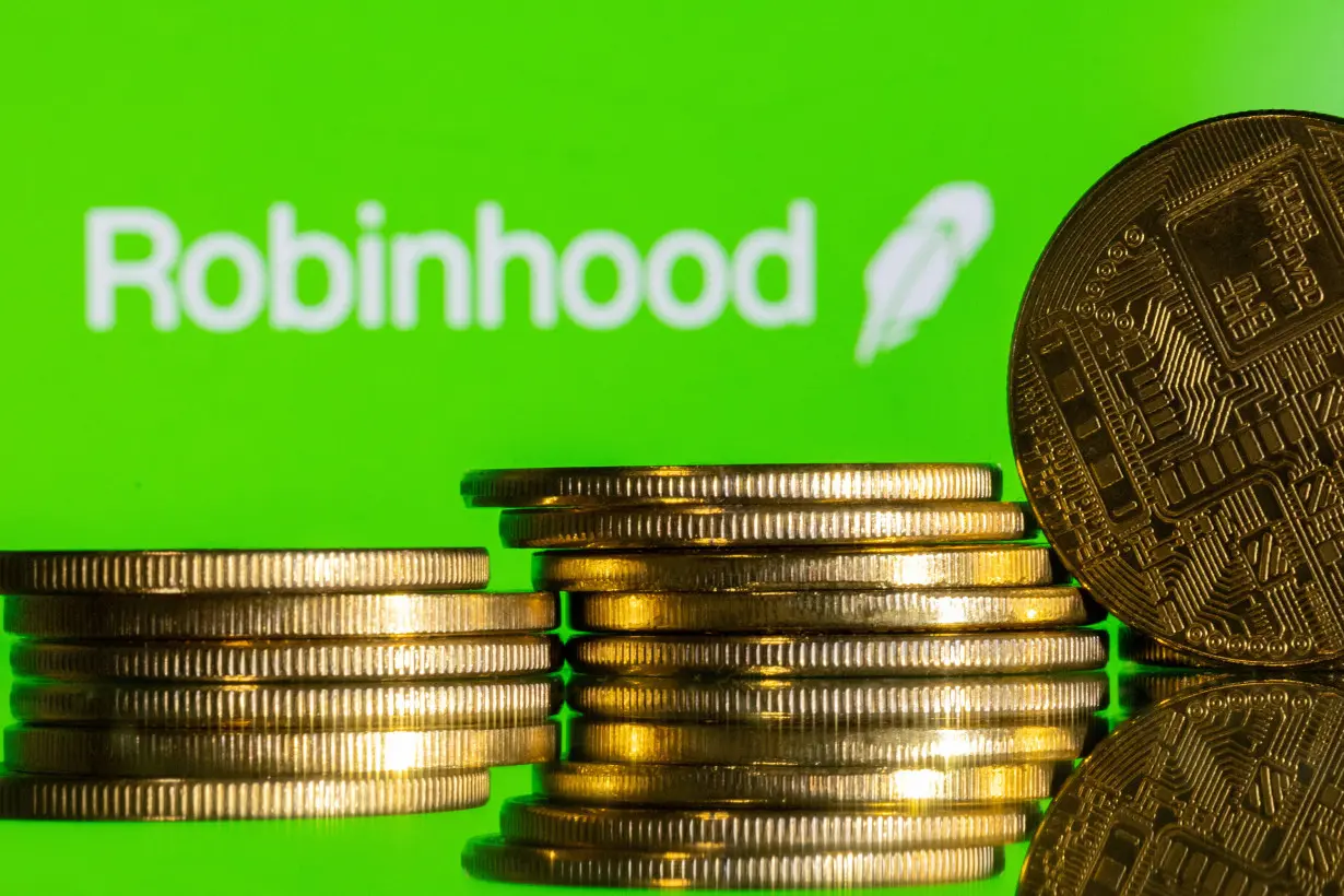 Illustration shows Robinhood logo and representations of cryptocurrency