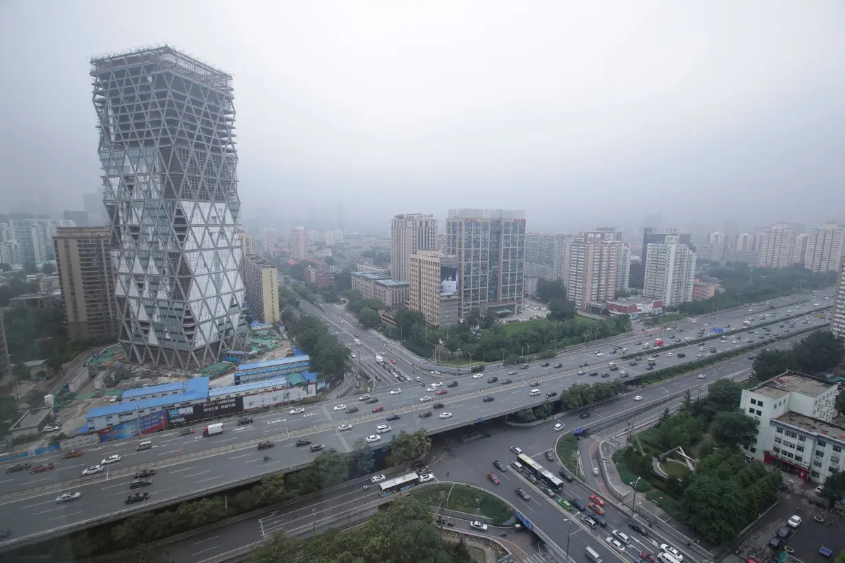 An uncompleted building is seen next to the Fourth Ring Road in Beijing