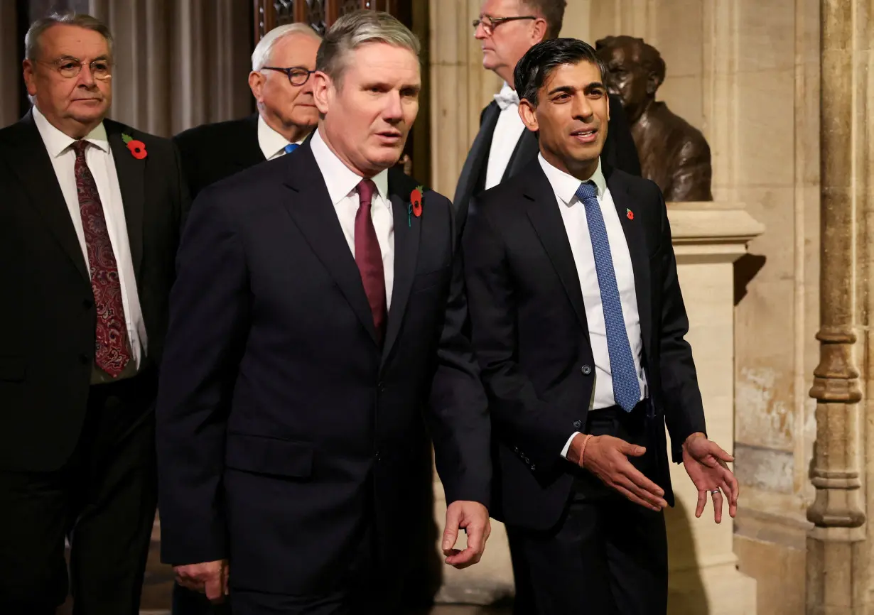 FILE PHOTO: Labour Party leader Sir Keir Starmer walks with Britain's Prime Minister Rishi Sunak during the State Opening of Parliament ceremony, at the Houses of Parliament