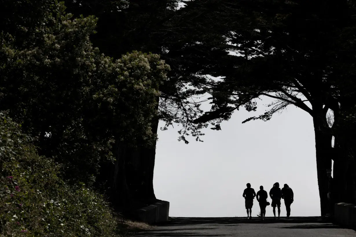 FILE PHOTO: People walk along a road at the Golden Gate National Parks Conservancy in San Francisco