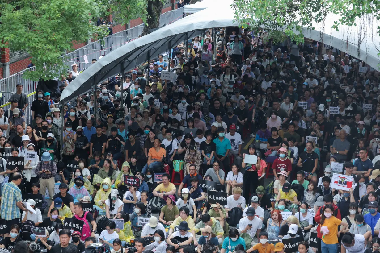 People gather outside the parliament during parliamentary session in Taipei