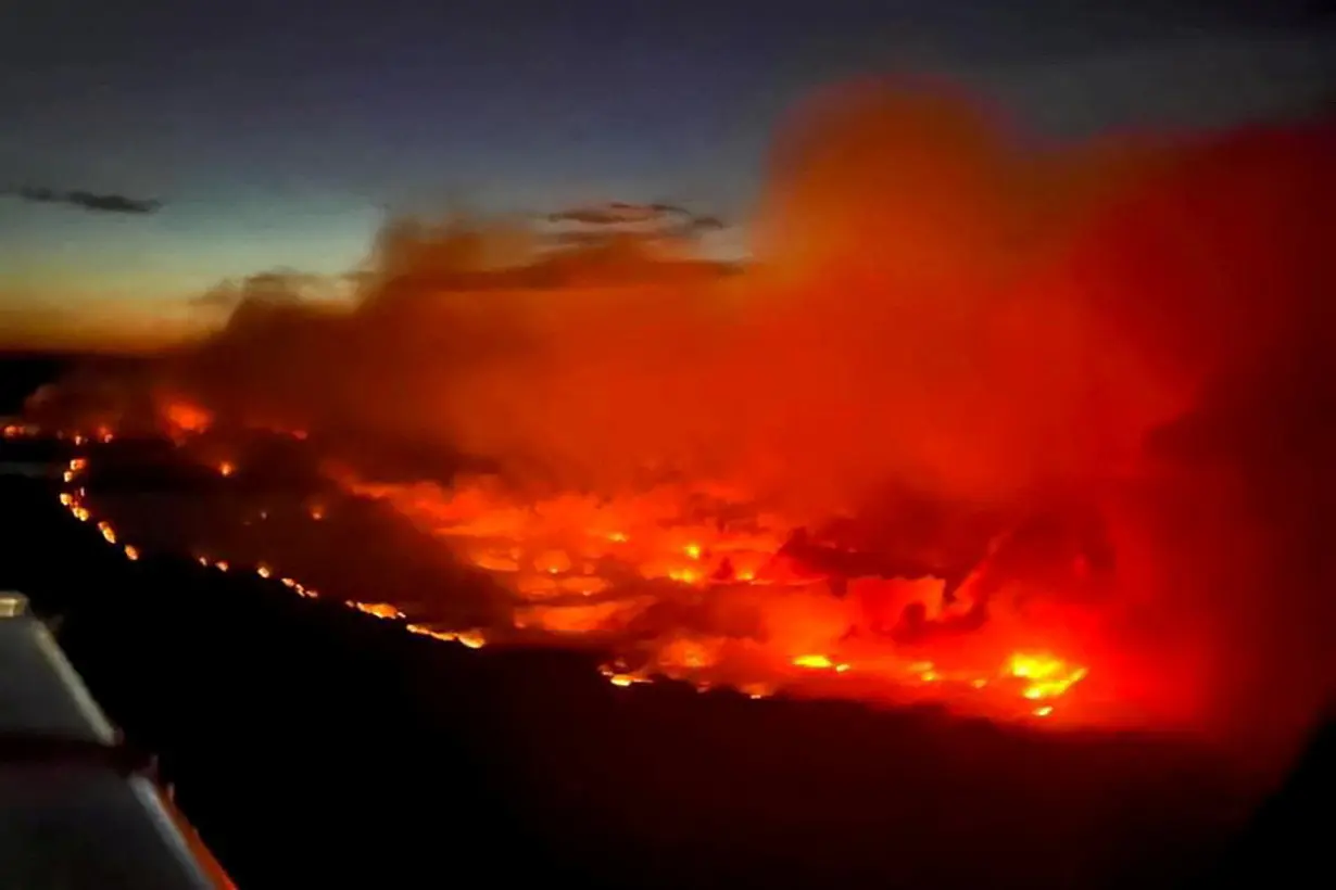 FILE PHOTO: The Parker Lake wildfire glows in an aerial photograph taken by a B.C. Emergency Health Services crew member