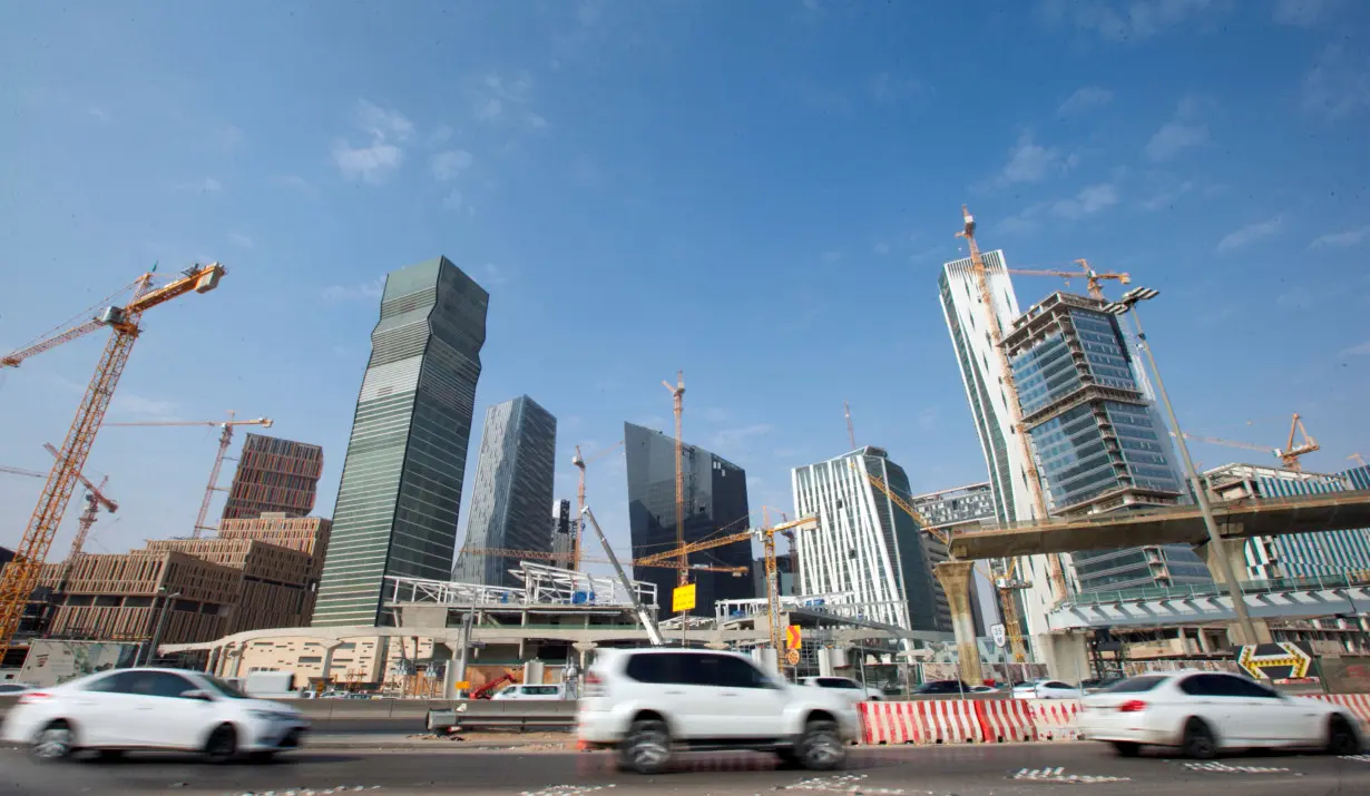 Cars drive past the King Abdullah Financial District in Riyadh